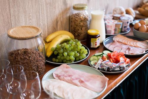 a table topped with plates of food and other foods at Penzion Dubina in Litoměřice