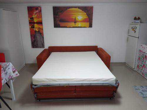 a bed in a room with a white mattress at Sole...Mare...e...Spiaggie Bianche! in Vada