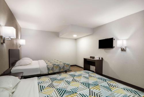 a hotel room with two beds and a flat screen tv at Motel 6-Sandston, VA - Richmond, Va in Sandston