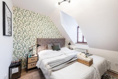 a bedroom with a large bed and a wall covered in flowers at Penzion Dubina in Litoměřice