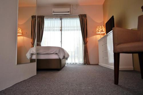 a bedroom with a bed and a large window at The Ocean Residence Langkawi in Kuah