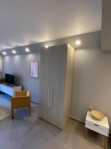 a living room with a cabinet and a table at Marion Apartments in Kourouta