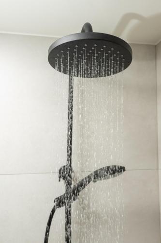 a shower with water hanging from a ceiling at Villa Oliveto in Tavronitis