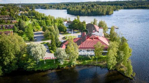 une île au milieu d'un lac avec un bâtiment dans l'établissement Hotel Kumpeli Spa, à Heinola