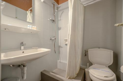 a bathroom with a toilet and a sink at Hotel Coronis in Naxos Chora