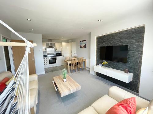 a living room with a hanging hammock in a room at The Lansdowne Hideaway - Brought to you by Coastline Retreats - Newly Refurbished Town centre, Close to beach, Large Jet bath with TV, Netflix, swing and Parking Included in Bournemouth
