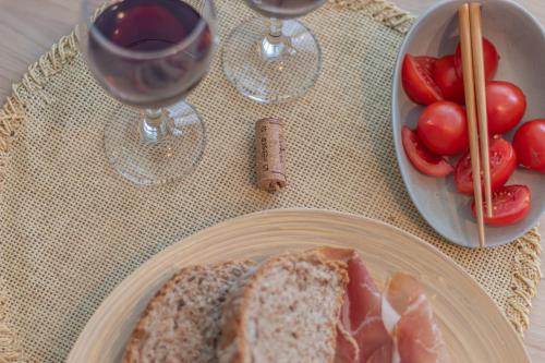 a table with a plate of bread and a bowl of tomatoes at Galvani Apartments in Terni