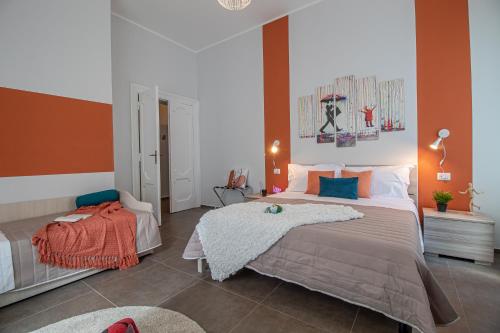 a bedroom with two beds and an orange wall at Galvani Apartments in Terni