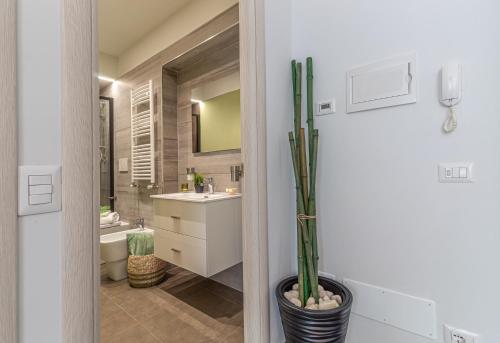 a bathroom with a sink and a toilet and a mirror at Galvani Apartments in Terni