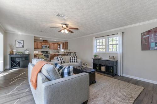 a living room with a couch and a ceiling fan at 4BR Ranch Style Home A Mile From Historic Downtown in Cartersville