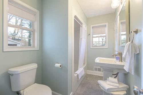 a bathroom with a white toilet and a sink at 4BR Ranch Style Home A Mile From Historic Downtown in Cartersville