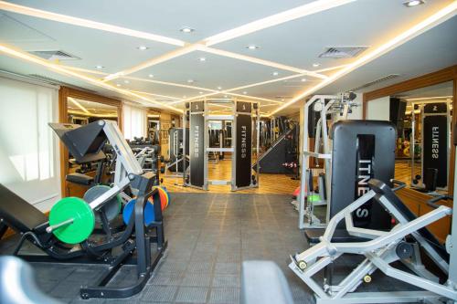 a gym with several treadmills and machines at Royal Swiss Lahore in Lahore