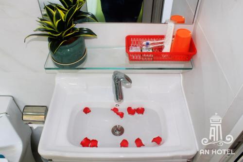 a bathroom sink with red hearts on it at An Hotel Phan Thiết in Phan Thiet