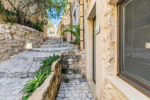 an alley in an old town with stone stairs at Scicli Albergo Diffuso in Scicli
