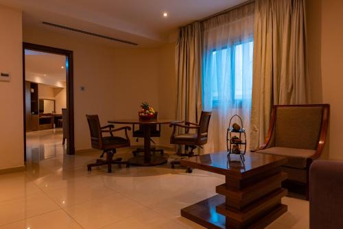 a living room with a dining room table and chairs at Pyramid Continental Hotel in Juba