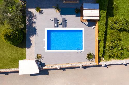 an overhead view of a swimming pool on a house at Costa Costa Villa - Luxury villa in Kolimbia