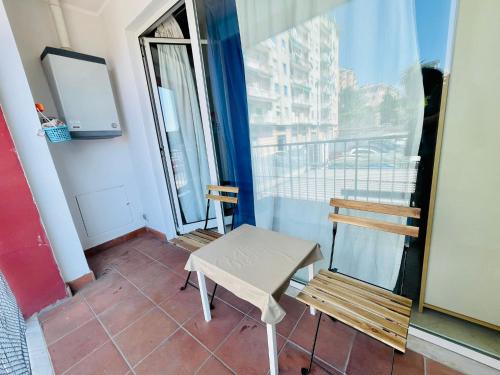 a room with a table and two chairs on a balcony at AIRPORT HOUSE MARIEl in Genoa