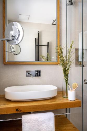 a bathroom with a white sink and a mirror at Alpin Residenz Dachsteinperle in Ramsau am Dachstein