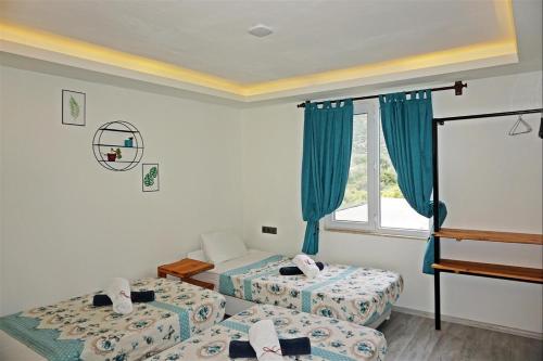 A bed or beds in a room at Kaş 11 Oda Boutique Pension