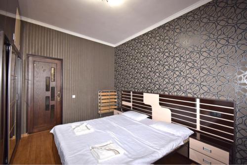 a bedroom with a large bed with white sheets at Argishti Street, 1 bedroom Modern apartment GL131 in Yerevan