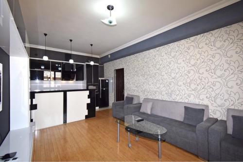 a living room with a couch and a table at Argishti Street, 1 bedroom Modern apartment GL131 in Yerevan