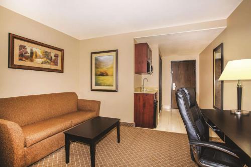 a living room with a couch and a table at La Quinta by Wyndham Ely in Ely