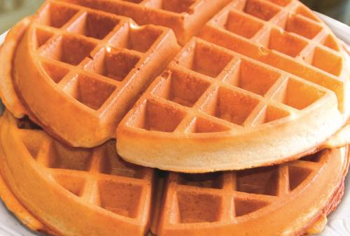 a stack of waffles on a white plate at La Quinta by Wyndham Ely in Ely
