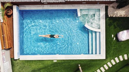 a person swimming in a swimming pool at Silver Sea Holiday Apartments in Ayia Napa