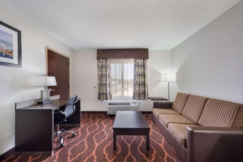 a living room with a couch and a desk at Quality Inn & Suites Huntsville Research Park Area in Huntsville