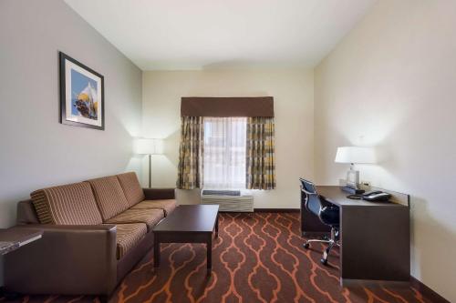 a living room with a couch and a desk at Quality Inn & Suites Huntsville Research Park Area in Huntsville