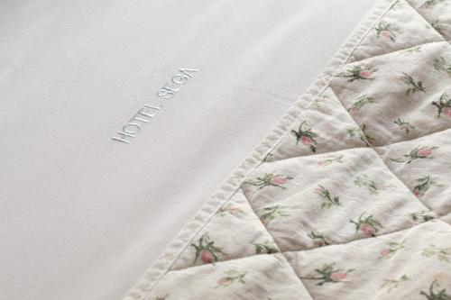 a close up of a quilt with strawberries on it at Hotel Segas in Loutraki