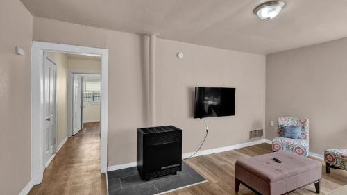 a living room with a tv and a chair at A Break Away from the Everyday! in Colorado Springs