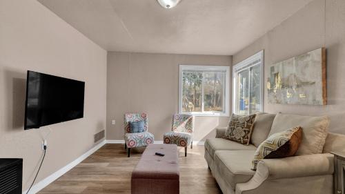 a living room with a couch and a flat screen tv at A Break Away from the Everyday! in Colorado Springs