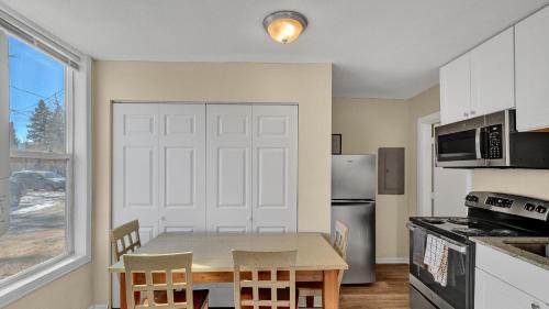 a small kitchen with a table and a refrigerator at A Break Away from the Everyday! in Colorado Springs