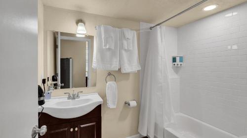 a white bathroom with a sink and a shower at A Break Away from the Everyday! in Colorado Springs