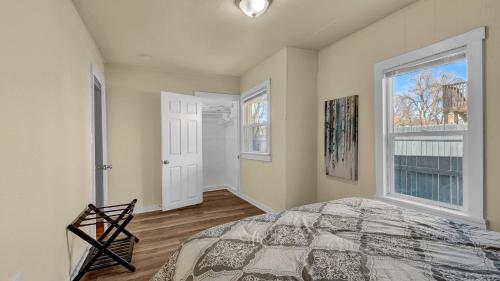 a bedroom with a bed and a large window at A Break Away from the Everyday! in Colorado Springs