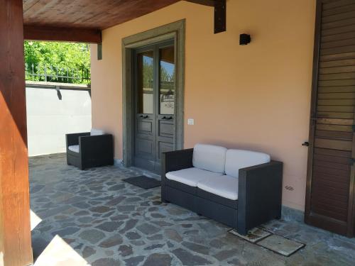 a porch with a chair and a door and a speaker at B&B via Piave da Lillo in Frosinone