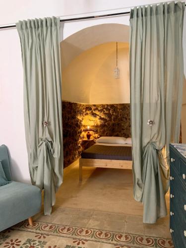 a bedroom with a bed and a window at Waterfront Villa in Pantelleria