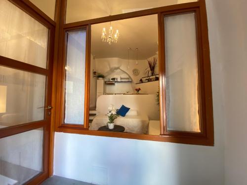a room with a window with a bed in it at La Verde di Vernazza - Art Studio - AC&WiFi - Vernazzarentals in Vernazza