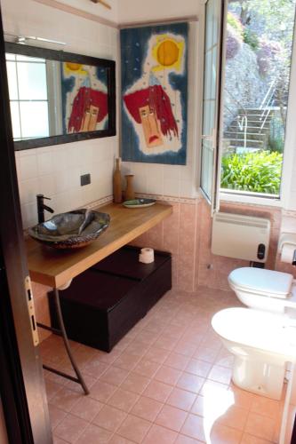 a bathroom with a sink and a toilet at Azalea in Recco