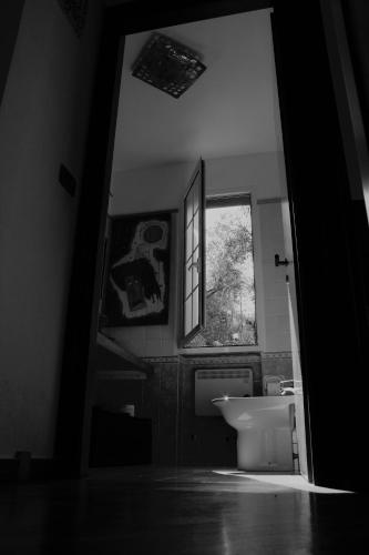 a bathroom with a sink and a toilet and a window at Azalea in Recco