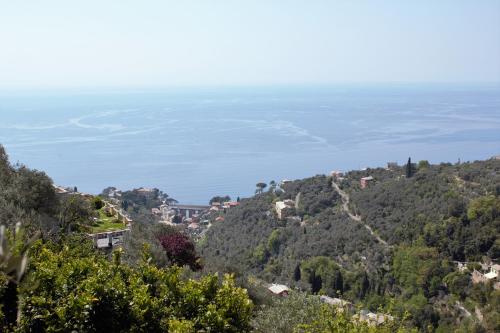 a view from the hillside of a town and the ocean at Azalea in Recco