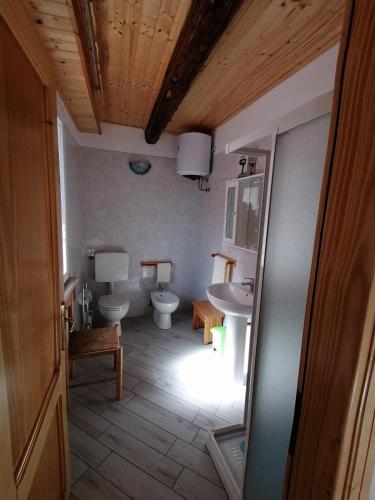 a bathroom with two toilets and a sink at Al Souvenir in Comacchio