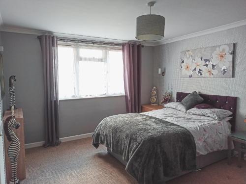 a bedroom with a bed and a guitar in it at Esplanade Court Apartment with communal seasonal heated pool in Paignton