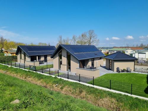 a rendering of a house with solar panels on it at Chalet met Sauna en Airconditioning in Sint Annaland
