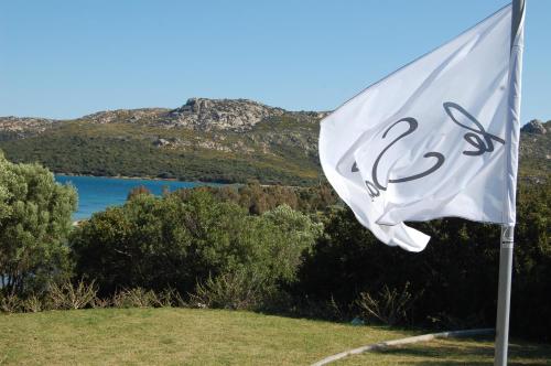a white flag flying in front of a lake at Le Ville Le Saline in Palau
