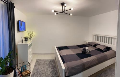 a bedroom with a bed with a black and brown blanket at Citadella House Targu Mures in Târgu-Mureş