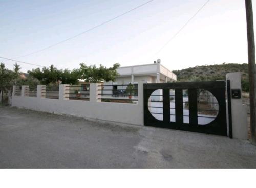 a fence with a gate in front of a house at AMMOS in Salamís