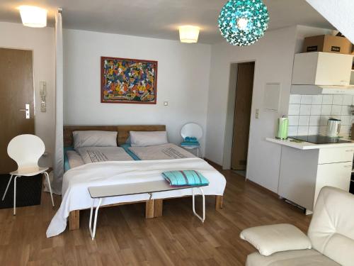 a bedroom with a bed and a table in it at Studio Ochsenfurt mit sonnigem Balkon in Ochsenfurt
