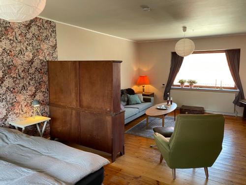 a living room with a bed and a couch at Retro bolig - fyldt med hygge! Ingen luksus in Kolind